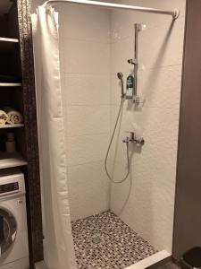 a shower stall in a bathroom with a shower at Bright apartment near Akropolis in Vilnius +29 photos