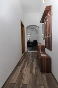 a hallway with wooden floors and a room with a table at Apartment Afrodita in Kaštela