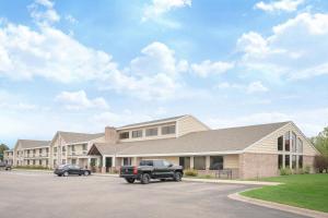 a truck parked in a parking lot in front of a building at Baymont by Wyndham Lakeville in Lakeville