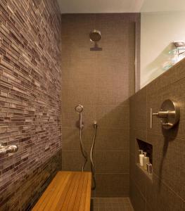 a shower with a wooden bench in a bathroom at Brewery Gulch Inn in Mendocino
