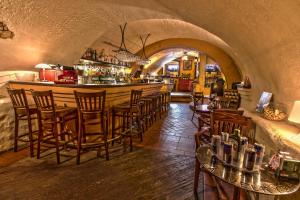 a restaurant with a bar with chairs and a counter at Studio Nicolas Prague in Prague