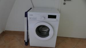 a white washer and dryer in a room at Ferienwohnung Mäder in Schaafheim