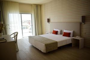
Uma cama ou camas num quarto em Ouril Hotel Agueda
