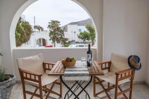 a table and chairs on a balcony with a window at Cultural House in Pyrgos