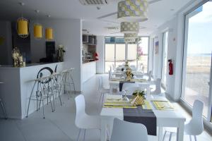 a dining room with white tables and white chairs at Ouril Hotel Agueda in Sal Rei