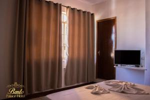 a bedroom with a bed and a window with curtains at Bento palace hotel in Assis +107 photos