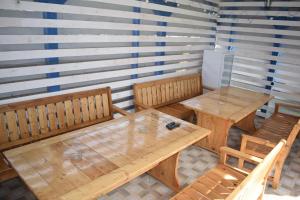a room with two wooden tables and two chairs at Casa Condrat in Sfântu Gheorghe