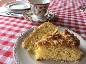 a piece of cake on a plate with a cup of coffee at Casa O Fabal in Sanxenxo