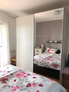 a mirror reflection of a bedroom with two beds at Apartment Danijela No. 2 in Novalja