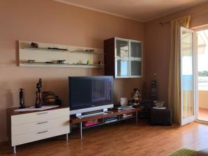 a living room with a flat screen tv on a desk at Apartment Danijela No. 2 in Novalja