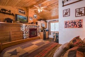 a bedroom with a bed and a fireplace in a cabin at Fireside Lodge in South Lake Tahoe