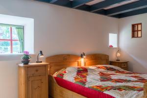 a bedroom with a wooden bed and a window at de Boskpleats in Winsum