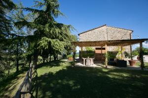 a house with a fence next to a yard at Tenuta San Filippo in Montalcino