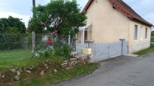 uma casa branca com uma cerca e um portão em Chez Mamie em Beynat