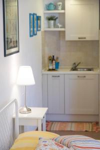 a kitchen with a bed and a table with a lamp at Il Casale Di Montefreddo in Sirolo
