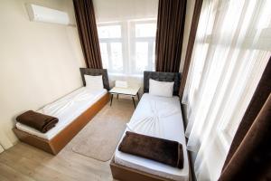 - 2 lits dans une chambre avec fenêtre dans l'établissement Yellow Rose Pansiyon, à Çanakkale