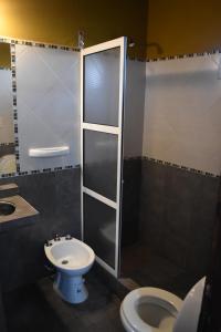 a bathroom with a shower and a toilet and a sink at Esquina Apart in Esquina