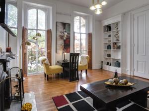 a living room with a table and yellow chairs at Downtown Memphis Shellcrest Apartments in Memphis