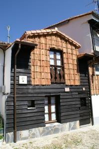 a wooden house with a brown roof at La Cuestecilla in Hervás