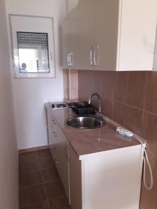 a kitchen with a sink and a counter top at Korac Apartments in Ulcinj
