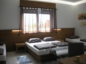 a room with two beds and a window at B&B Il Crocevia in Teglio
