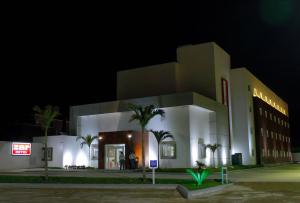 a large white building with palm trees in front of it at Zar Coatzacoalcos in Coatzacoalcos