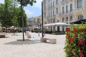 a man is standing on a street in a city at Lisbon Prime Hostel & Rooms in Lisbon