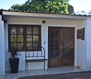 a bench sitting in front of a door at Esquina Apart in Esquina