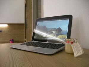 a laptop computer sitting on top of a wooden table at B&B Il Crocevia in Teglio