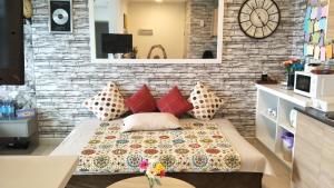 a bedroom with a bed with pillows and a brick wall at Non Smoking Theda Evo Soho Bangi with Coway & Wifi - Pool Tutup in Bangi +16 photos