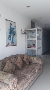a living room with a couch and a picture on the wall at Hospedaje Harjeny in Trujillo