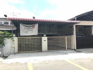 a building with a gate with a sign on it at Cempaka Homestay Batu Pahat in Batu Pahat
