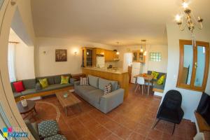 a living room with a couch and a table at The L Villa in Nea Peramos