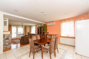 a kitchen and dining room with a table and chairs at Birutes Houses in Druskininkai