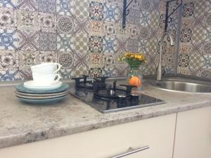 a kitchen counter with a stove and a sink at Marinas Guesthouse in K'obulet'i +33 photos