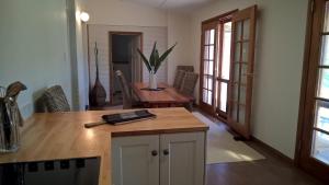 a kitchen with a table and chairs and a dining room at Book Keepers Cottage in Waikerie