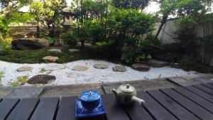 a garden with a table with a tea pot on it at Kinkaku in Kyoto
