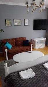 a living room with a coffee table and a couch at Mirka Apartment in Gdynia