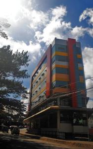 a large building with a bus parked in front of it at Hotel 45 in Baguio