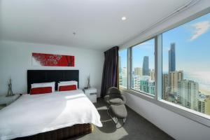 a bedroom with a large bed and a large window at Private Q1 Resort & Spa Apartment with Ocean Views in Gold Coast