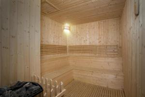 a wooden sauna with a light on top of it at Somerset Harmony City Wuxi in Wuxi