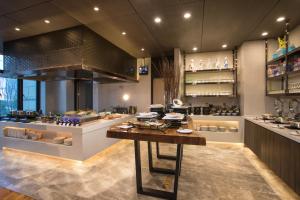a kitchen with a counter with food on it at Somerset Harmony City Wuxi in Wuxi