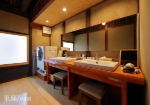 a bathroom with two sinks and a large mirror at Houka in Kyoto