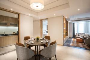a dining room with a table and chairs at Somerset Harmony City Wuxi in Wuxi