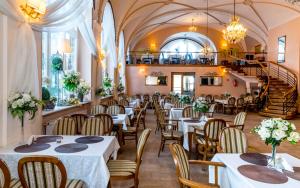 a restaurant with tables and chairs and a staircase at Dom Zdrojowy in Świeradów-Zdrój