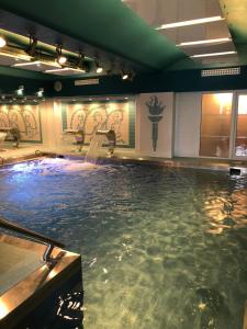 a swimming pool with a water fountain in a building at Dom Zdrojowy in Świeradów-Zdrój