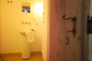 a bathroom with a towel hanging on the wall at Ferienhaus Troadkasten - Familie Friedrich in Hartberg