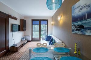 クリニツァ・モルスカにあるLuksusowe apartamenty Przy Plaży-Continentalのリビングルーム(ソファ、青い椅子2脚付)