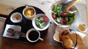 una mesa con un plato de comida y un tazón de ensalada en Kamakurayama Farm - B&B Satoyama, en Uda