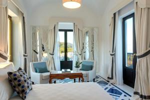a bedroom with two beds and a table and chairs at Anna Belle Elegant AgriResort in Sorrento
